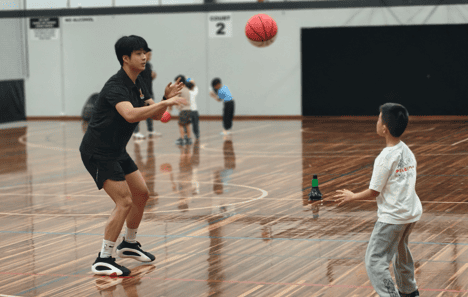 Young child practicing dribbling during basketball lessons near me at First Pick Basketball in Melbourne, learning coordination and teamwork in a fun class for kids aged 4–8.
