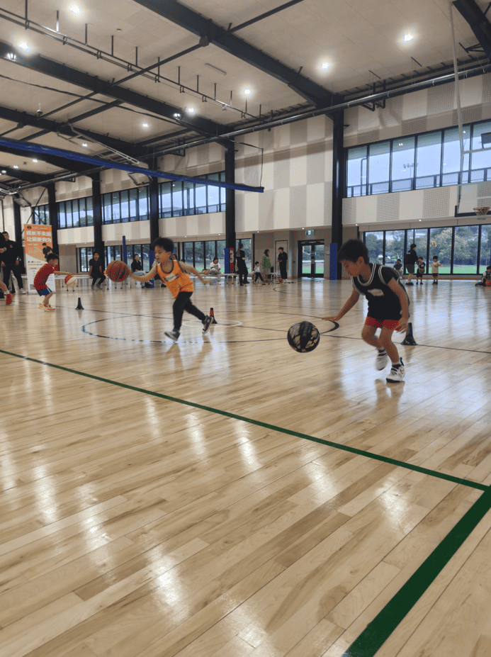 Children practicing dribbling and coordination drills in a basketball training session