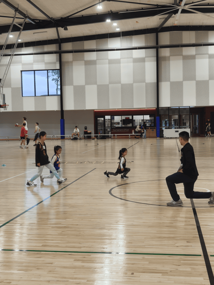 Kids playing fun warm-up basketball games indoors, building balance and flexibility.