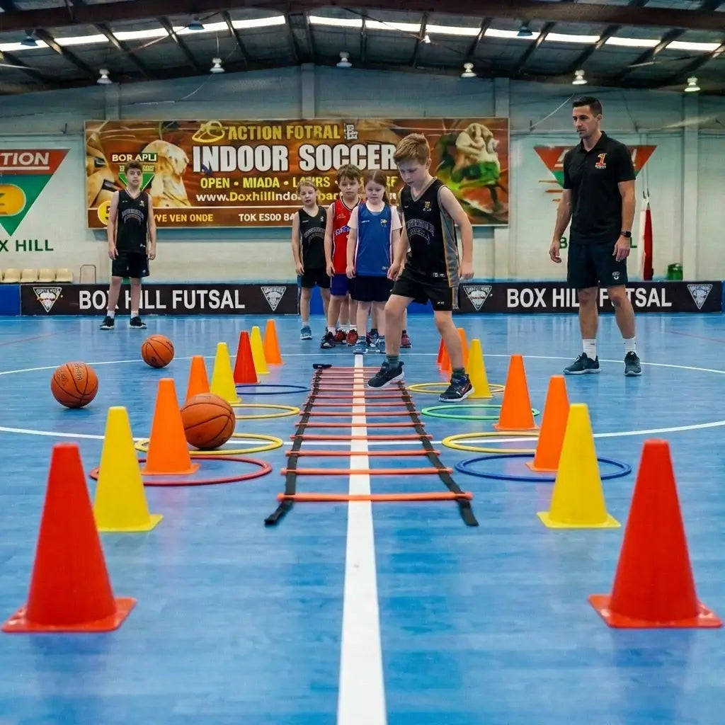 Professional basketball coaches conducting a weekend session for junior athletes on the blue courts at Box Hill South.