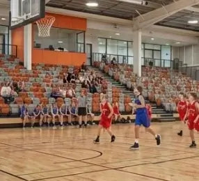 A focused 12-year-old male basketball player with a determined expression, representing the 10-14 age group of First Pick EDP.