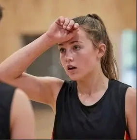 A confident young female basketball athlete smiling after an elite training session at Wheelers Hill.