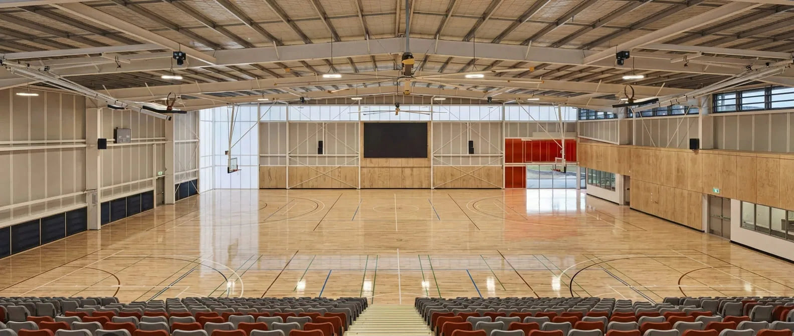 A high-end indoor basketball stadium at Wheelers Hill Secondary College, Melbourne. This professional venue features elite sprung timber flooring and tiered seating, providing an inspiring and safe environment for First Pick’s 5+3 scientific youth basketball development program.
