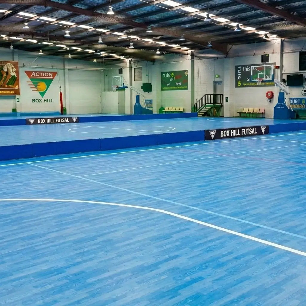The spacious blue high-traction basketball court at First Pick Academy's Box Hill South campus, designed for professional junior training.