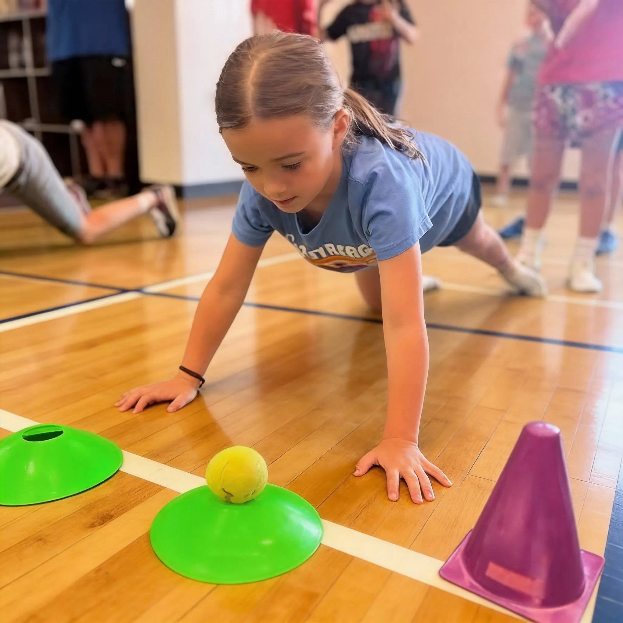 A toddler practicing coordination on a balance beam, focusing on the Balance pillar of the Grow and Go 5+3 system.
