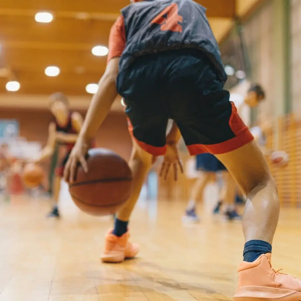 A high-intensity First Pick EDP training session at Wheelers Hill Secondary College, featuring elite coaching from Redroo pro players and Victoria Basketball referees for junior athletes aged 8-14.