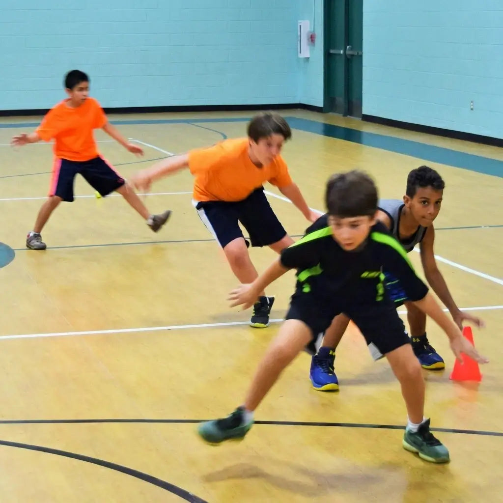 The high-performance wooden court at First Pick Clayton facility, featuring premium flooring and a clean, professional environment for junior basketball training.