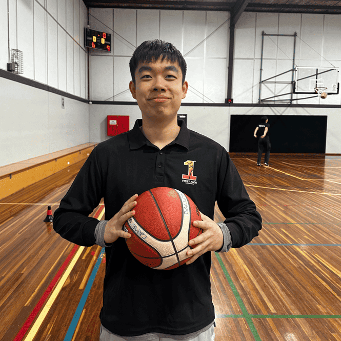 Positive young coach supporting kids basketball training